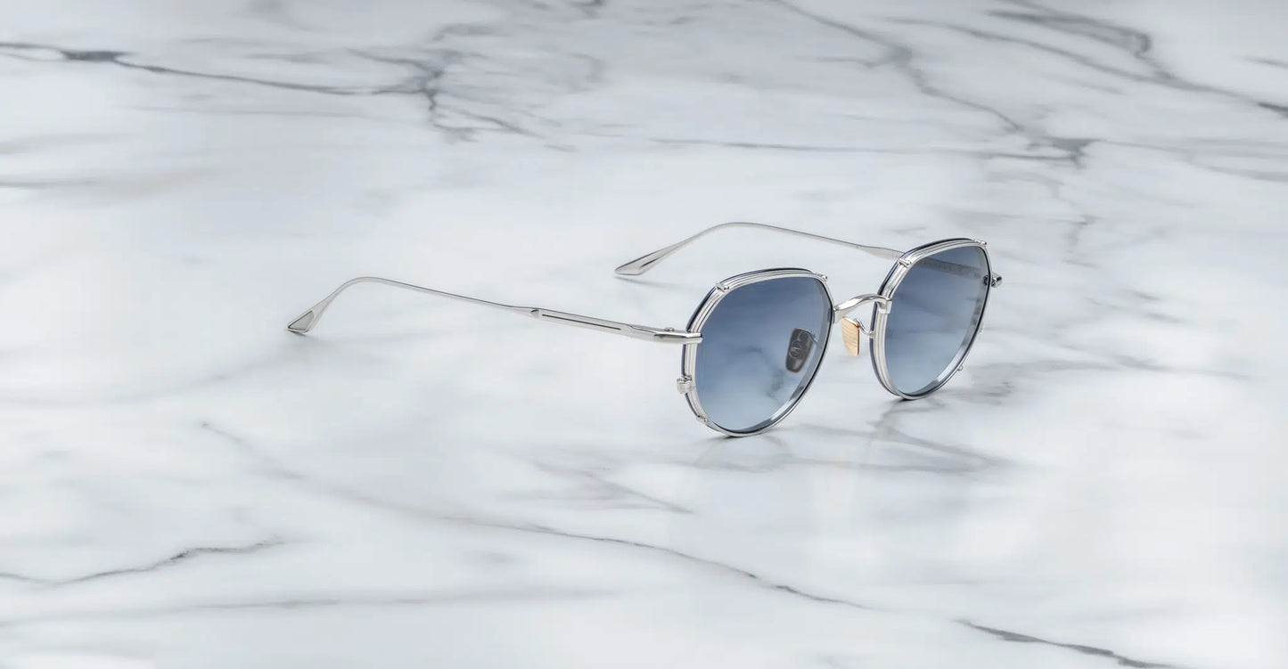 Jacques Marie Mage Hartana sunglasses in Fossil (silver with blue lenses).