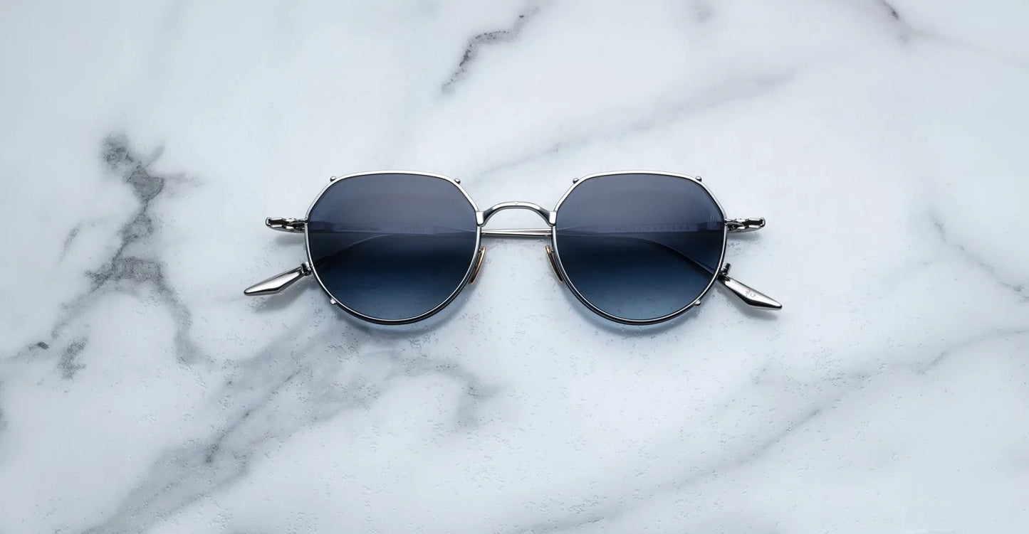 Jacques Marie Mage Hartana sunglasses in Fossil (silver with blue lenses).