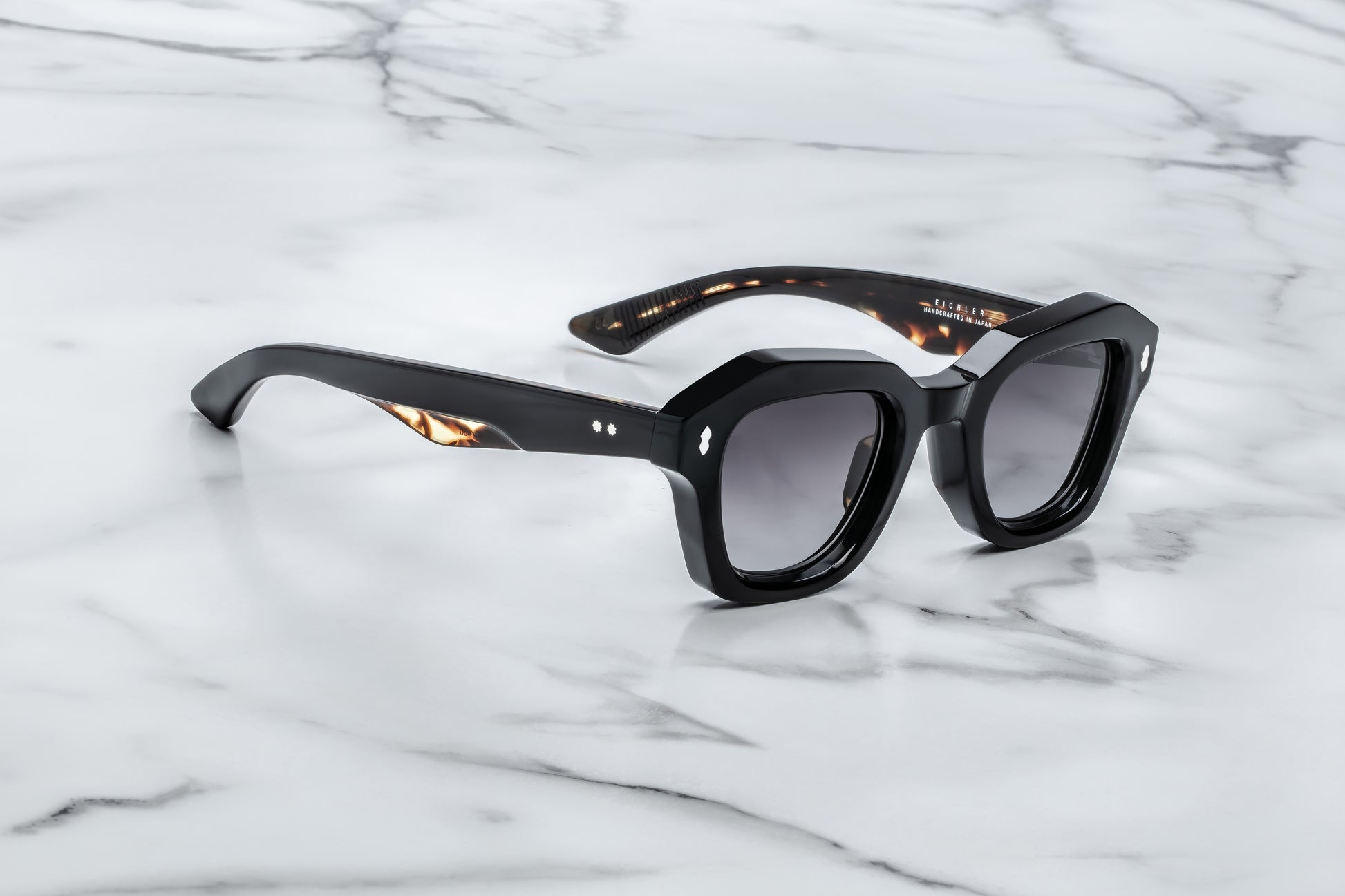 Black sunglasses on a marble surface
