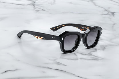 Black sunglasses on a marble surface
