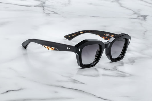 Black sunglasses on a marble surface