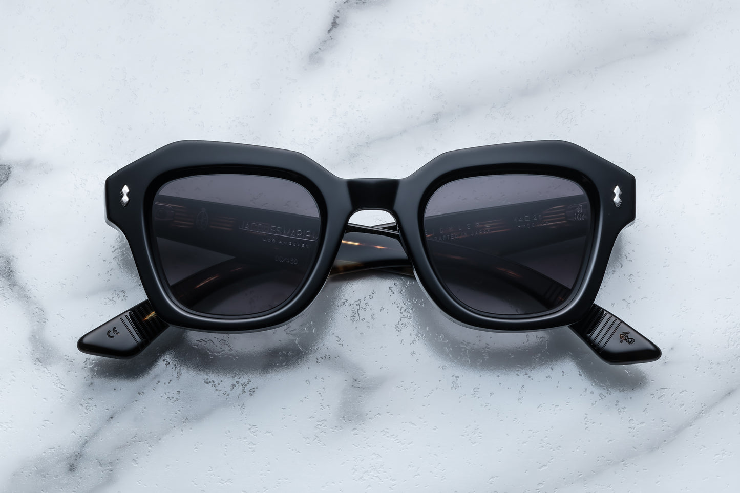 Black sunglasses on a marble surface