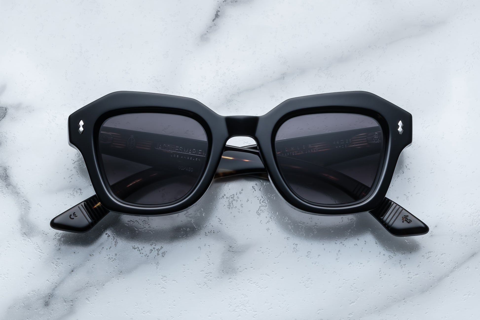 Black sunglasses on a marble surface