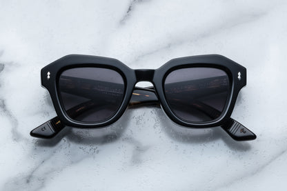 Black sunglasses on a marble surface