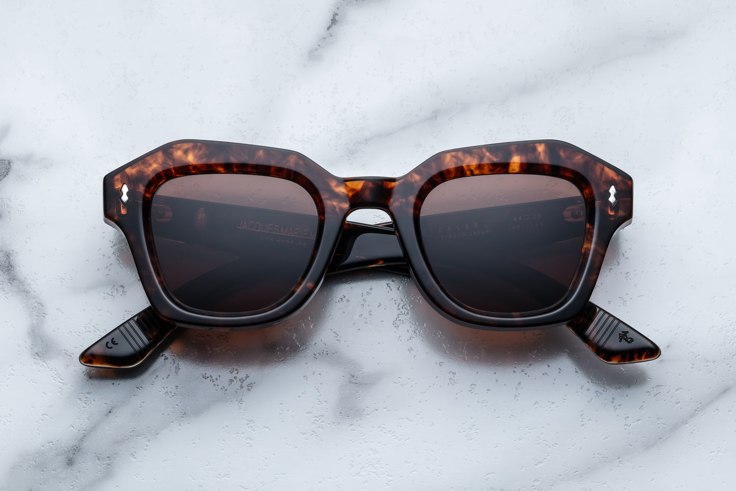 Tortoiseshell sunglasses on a marble surface